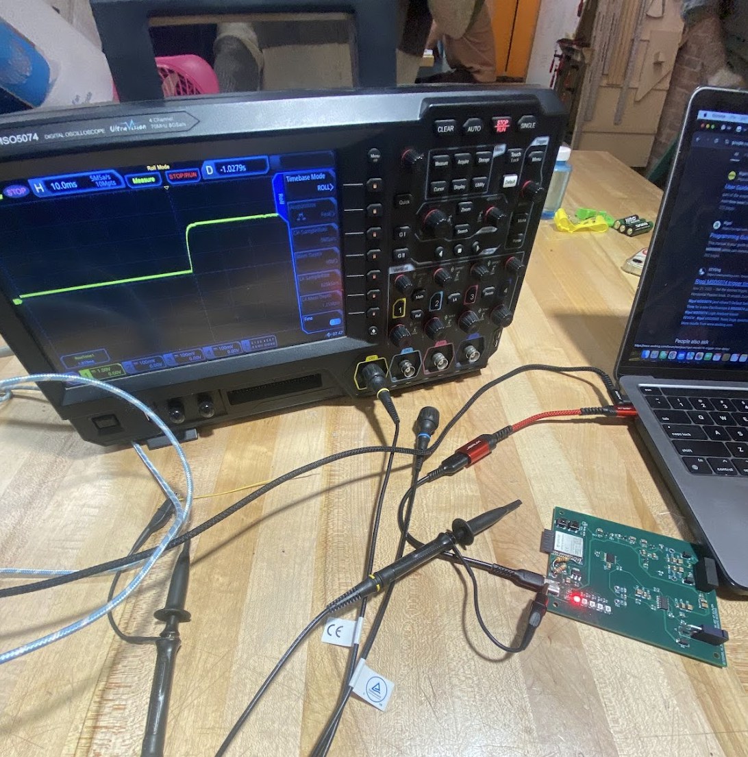 Four-channel oscilloscope probing the board during a powered startup
